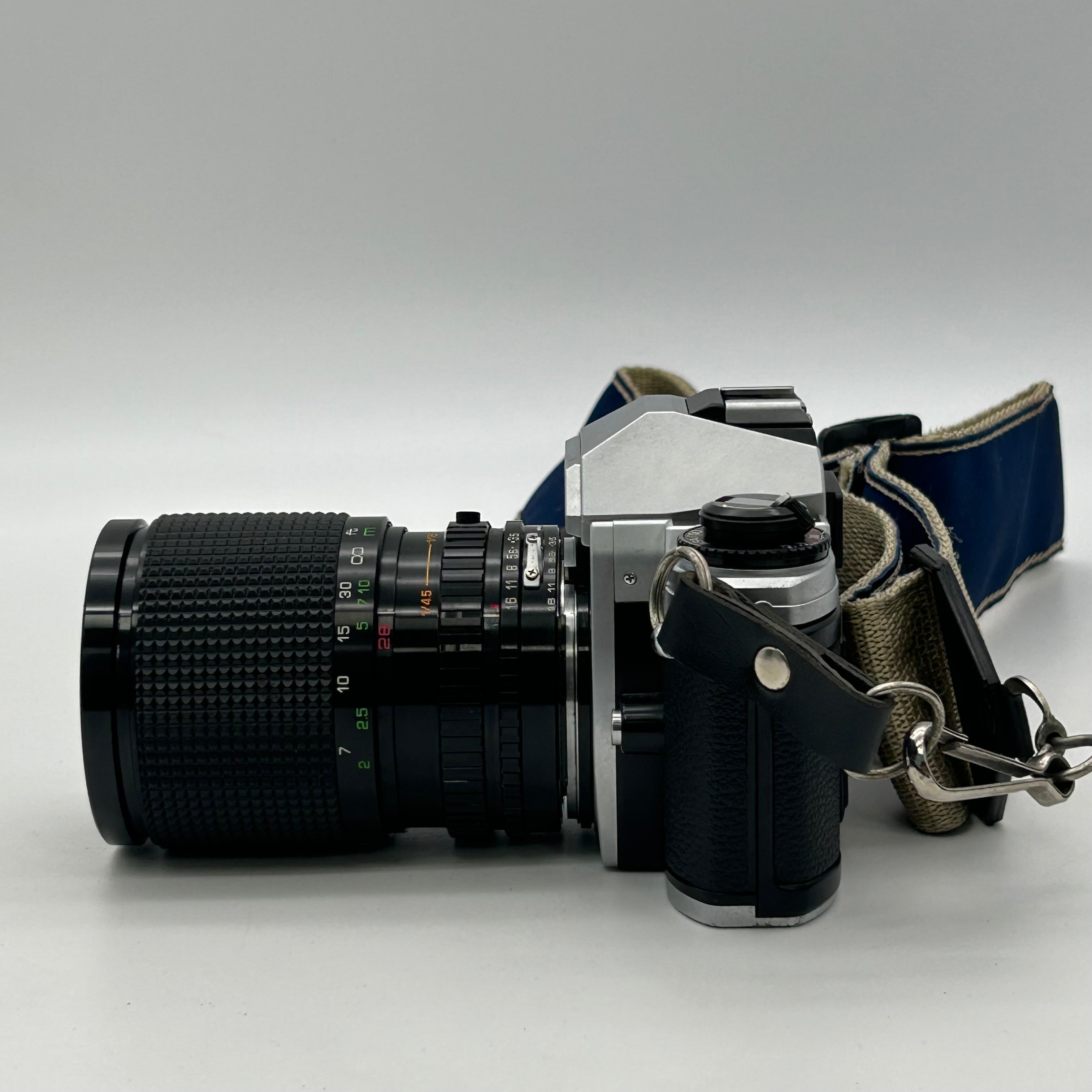Nikon FG-20 35mm SLR Film Camera Bundle w/ 2 Lenses (Rokinon, Sigma) - Untested