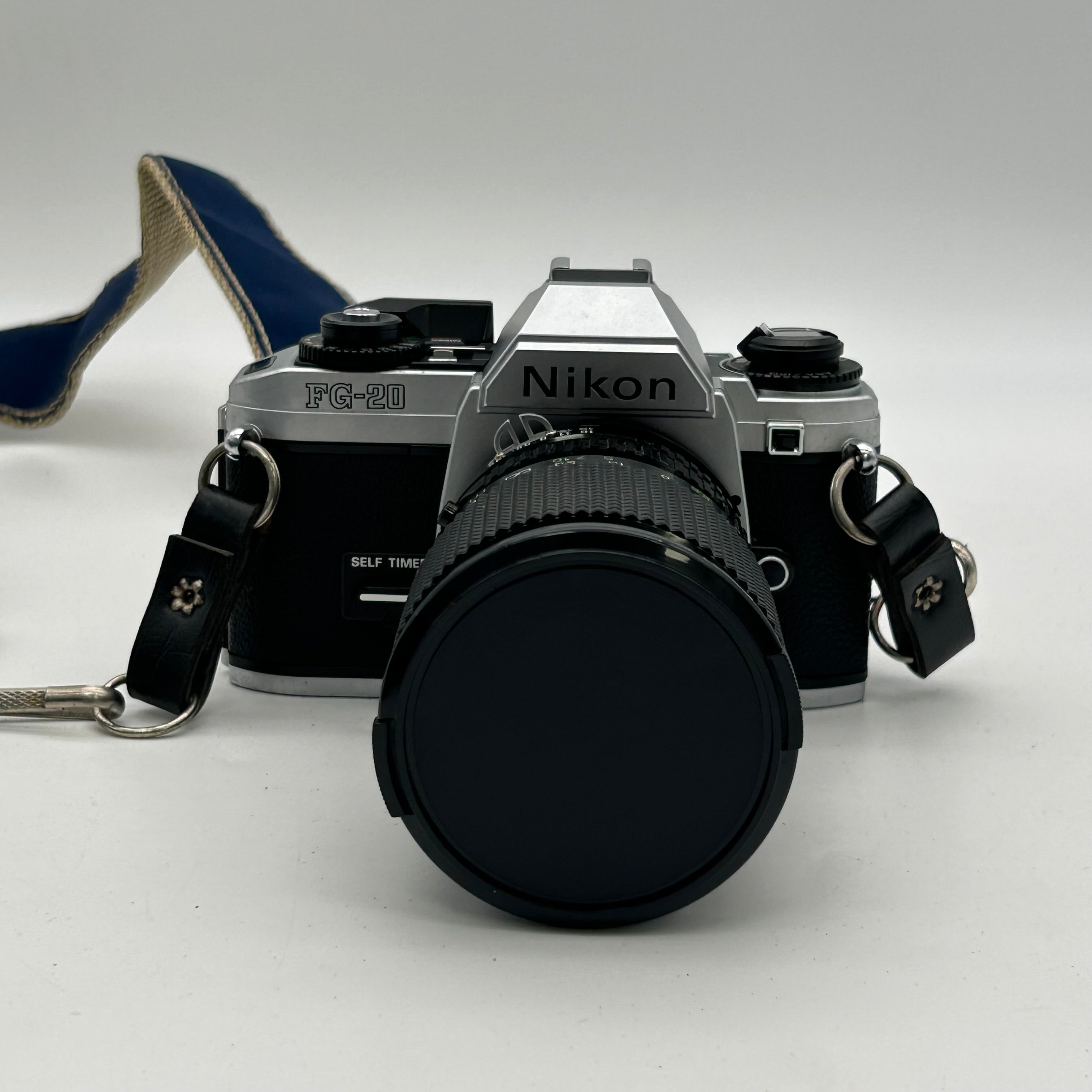 Nikon FG-20 35mm SLR Film Camera Bundle w/ 2 Lenses (Rokinon, Sigma) - Untested